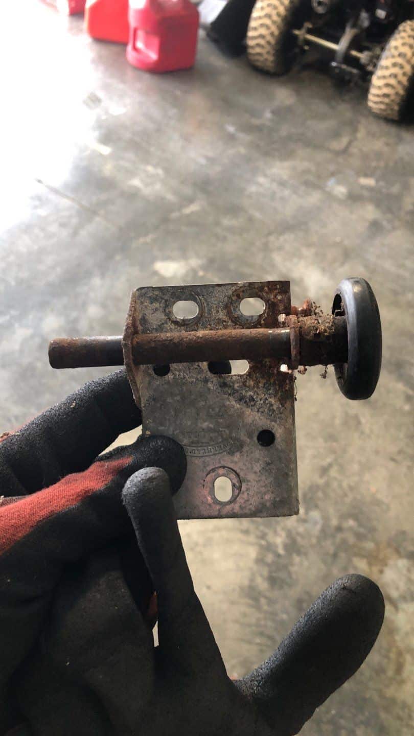 Residential garage door track and roller system showing wear and alignment concerns